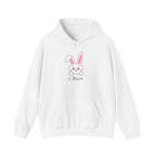 White hoodie with a pink bunny graphic and 'Olivia' text on a white background