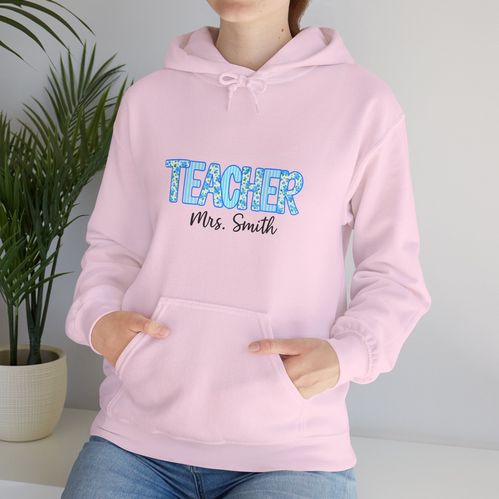 Person wearing a pink hoodie with 'TEACHER Mrs. Smith' text