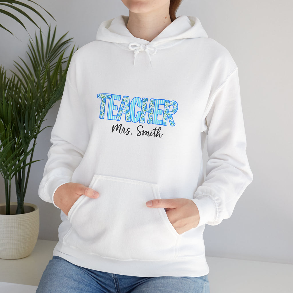White hoodie with 'TEACHER Mrs. Smith' text worn by a person, against a neutral background.