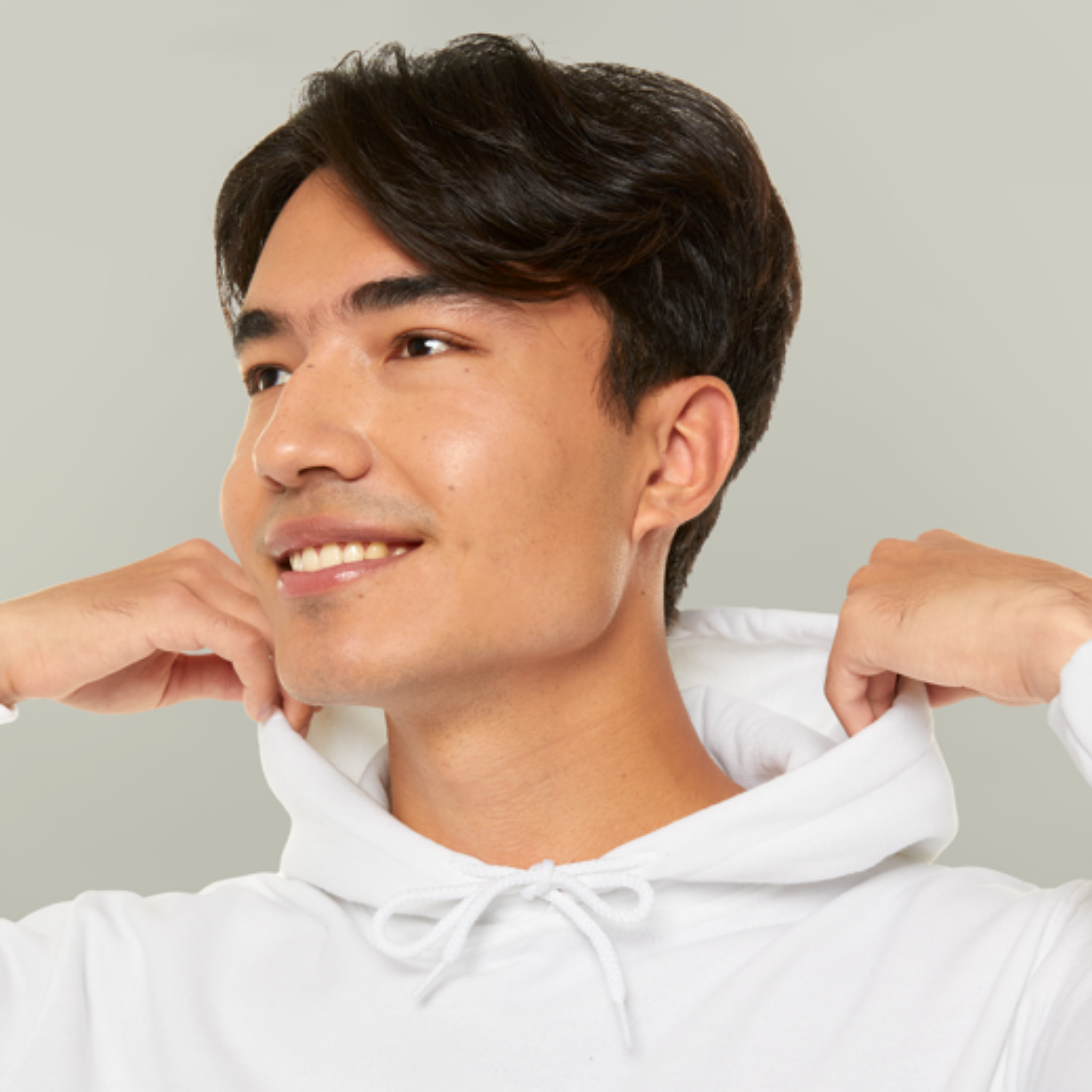 Man wearing a white hoodie against a plain background
